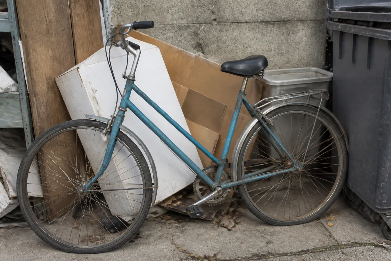 Älteres Fahrrad zwischen ausrangierten Gegenständen